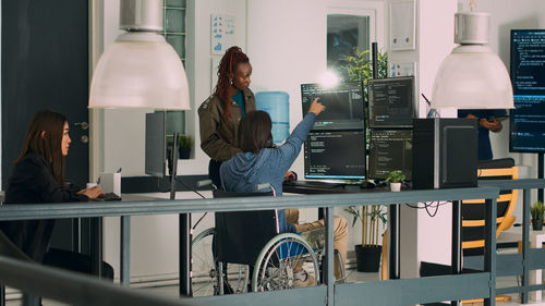 Side view of woman working at home