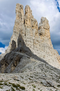 Low angle view of rock formation on land against sky