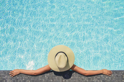 High angle view of man relaxing in swimming pool