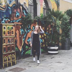 Full length of woman standing by railing