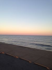 Scenic view of sea against clear sky during sunset