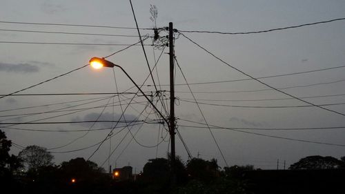 Low angle view of electricity pylon against sky