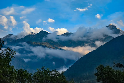 Scenic view of mountains against cloudy sky