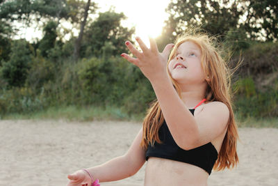 Carefree girl playing at beach
