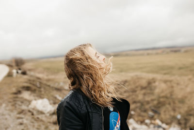 Rear view of woman on landscape against sky