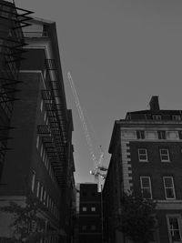 Low angle view of modern buildings against sky at night