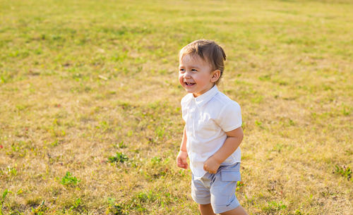 Happy boy standing on field