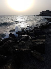 Scenic view of sea against clear sky at sunset