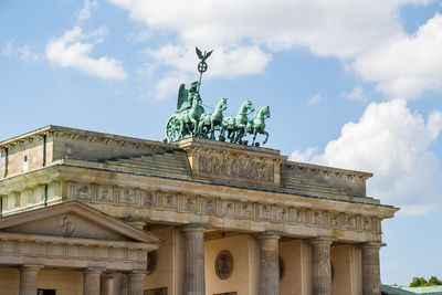 Low angle view of statue against cloudy sky