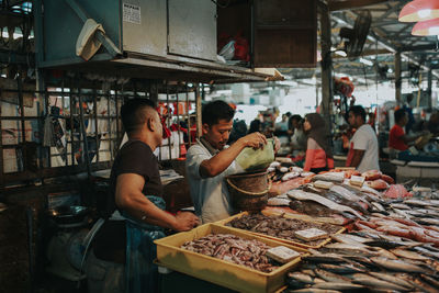 People working at market stall