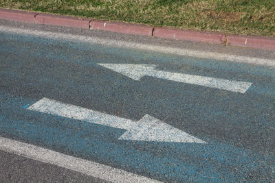 High angle view of arrow symbol on road in city