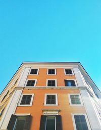 Low angle view of building against clear blue sky