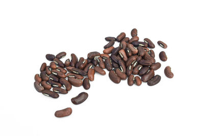 High angle view of coffee beans against white background