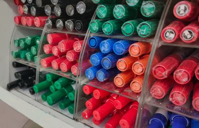 Full frame shot of multi colored bottles in shelf