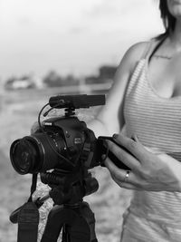 Midsection of woman photographing camera
