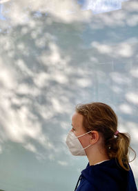 Rear view of girl looking against sky