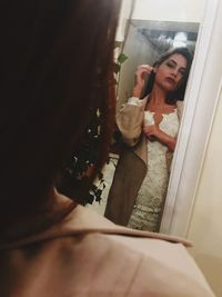 Young woman standing at home