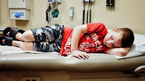 Cute boy sleeping on bed in hospital