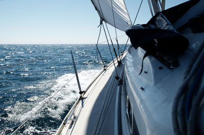 Sailboat sailing on sea against sky
