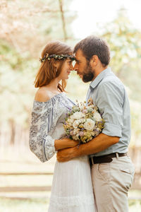 Side view of couple standing outdoors