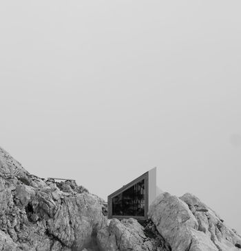 BUILT STRUCTURE ON ROCK AGAINST SKY
