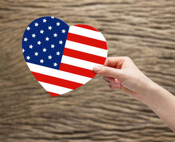 Midsection of person holding flag