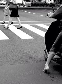 Low section of people walking on road