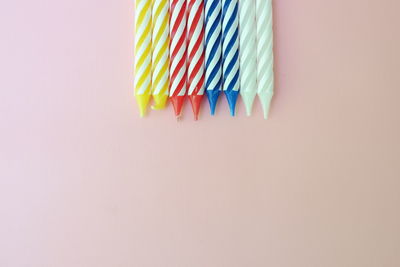 Close-up of colored pencils over white background