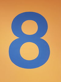Close-up of number on yellow wall