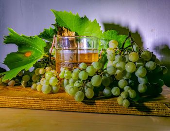 Close-up of fruits and leaves on table