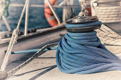 Close-up of rope tied to boat sailing in sea