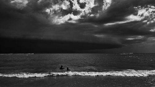 Scenic view of sea against storm clouds