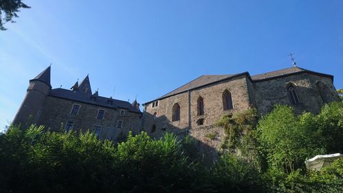 Low angle view of building against clear blue sky