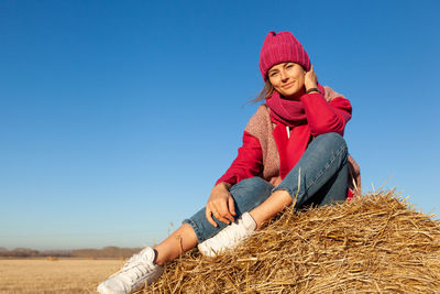 The concept of livestyle outdoor in autumn. close up of a young woman student in a warm autumn 