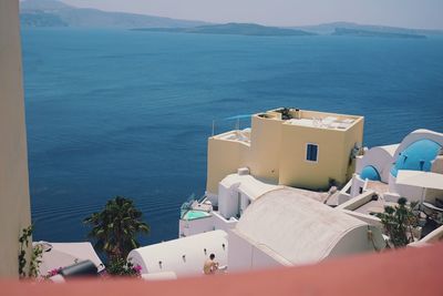 High angle view of buildings by sea against sky om oia