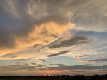 Low angle view of silhouette landscape against sky during sunset