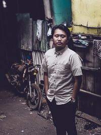 Portrait of young man standing in city