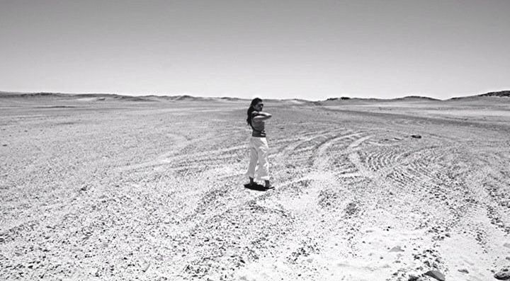 full length, lifestyles, sand, leisure activity, landscape, walking, standing, rear view, tranquil scene, clear sky, tranquility, casual clothing, copy space, shadow, day, desert, nature, solitude