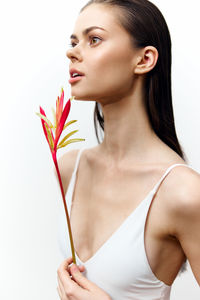 Portrait of young woman holding flower