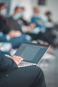Man with laptop having a presentation at seminar gathering
