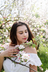 Portrait of young woman holding bouquet