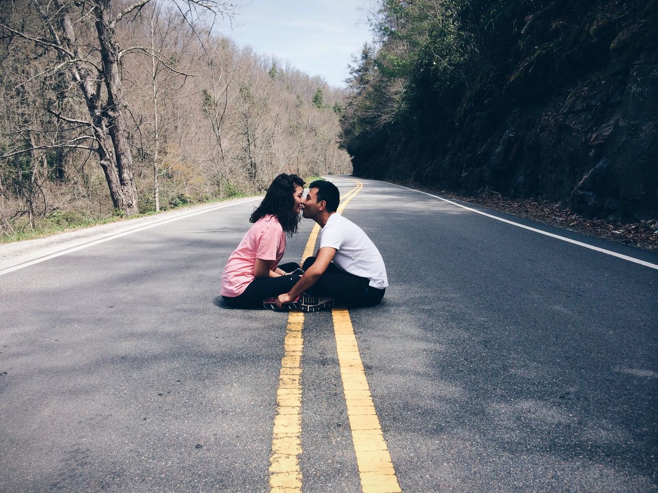 transportation, road, lifestyles, the way forward, leisure activity, road marking, full length, street, rear view, asphalt, casual clothing, diminishing perspective, tree, vanishing point, travel, country road, land vehicle, mode of transport