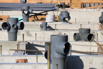 Close-up of pipes against wall on sunny day