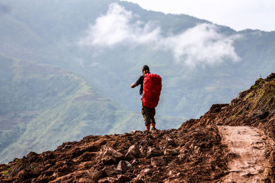 Rear view of hiker on mountain top