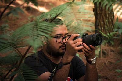 Portrait of young man photographing