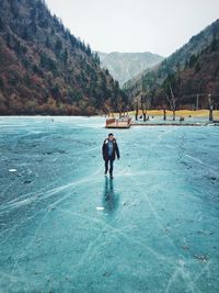 Full length of young man walking on frozen lake