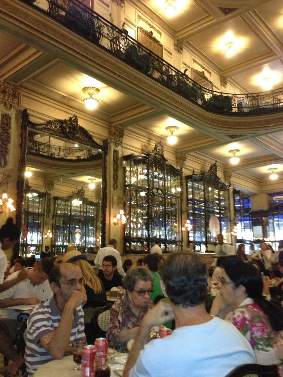 indoors, illuminated, ceiling, men, interior, store, retail, lighting equipment, person, lifestyles, large group of people, market, shop, shopping, leisure activity, sitting, architecture, built structure, small business