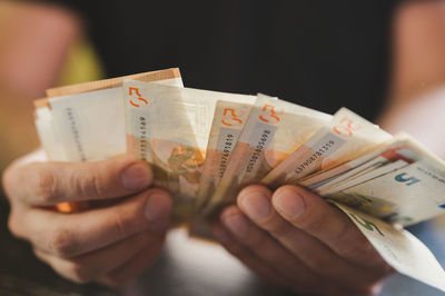 Business man counting money. male hands holds and count cash banknotes euros bills or notes currency