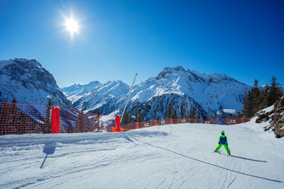 Scenic view of snowcapped mountains against clear blue sky