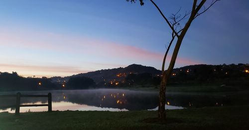 Scenic view of lake against sky at sunset